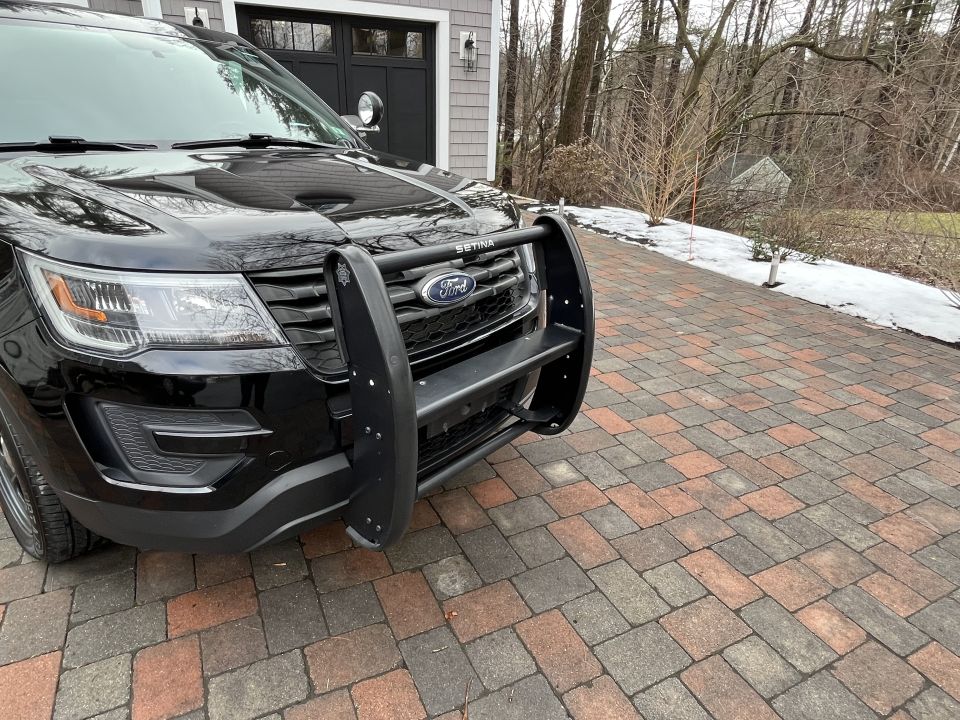 Close-up of black Ford SUV front grille and brush guard