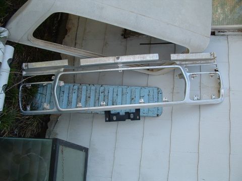 1979 Ford Bronco - A disassembled Ford Bronco grille and associated parts are laid out, possibly for repair or restoration.