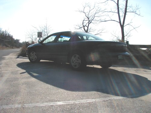 Dark 1995 Dodge Intrepid parked on asphalt, rear quarter view