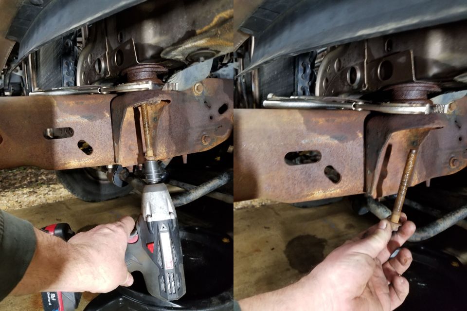 Close-up of rusty vehicle frame with a bolt being removed by an impact wrench