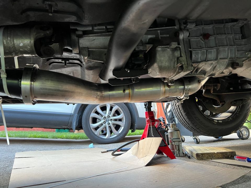 Downpipe all tacked in place. I cheated on the tacks under the car and just used the MIG. Not like it's going to rust away any time soon and it's a lot easier to zap a tack in with the MIG than trying to handle filler rod and the torch with the car on jack stands.