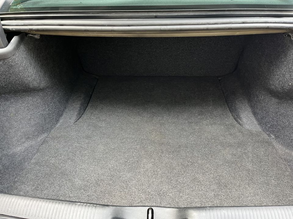 Empty carpeted sedan trunk cargo area