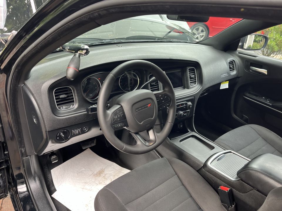 Dashboard and steering wheel of a black Dodge sedan interior
