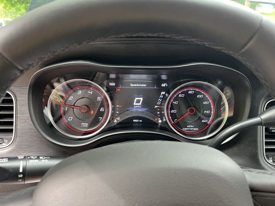 Dashboard gauges with a digital speedometer showing 0 MPH and an analog tachometer