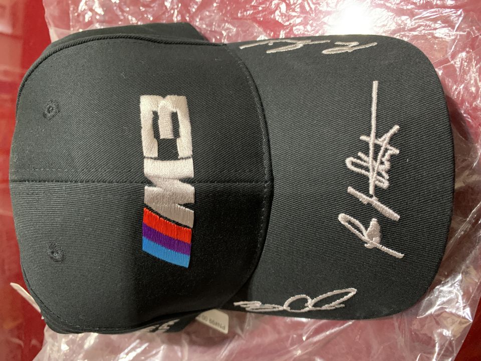 Black baseball cap with "M3" logo and embroidered signatures.
