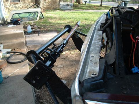 1979 Ford Bronco - Hydraulic jack attached to the front bumper of a vehicle, with a detached hardtop nearby.