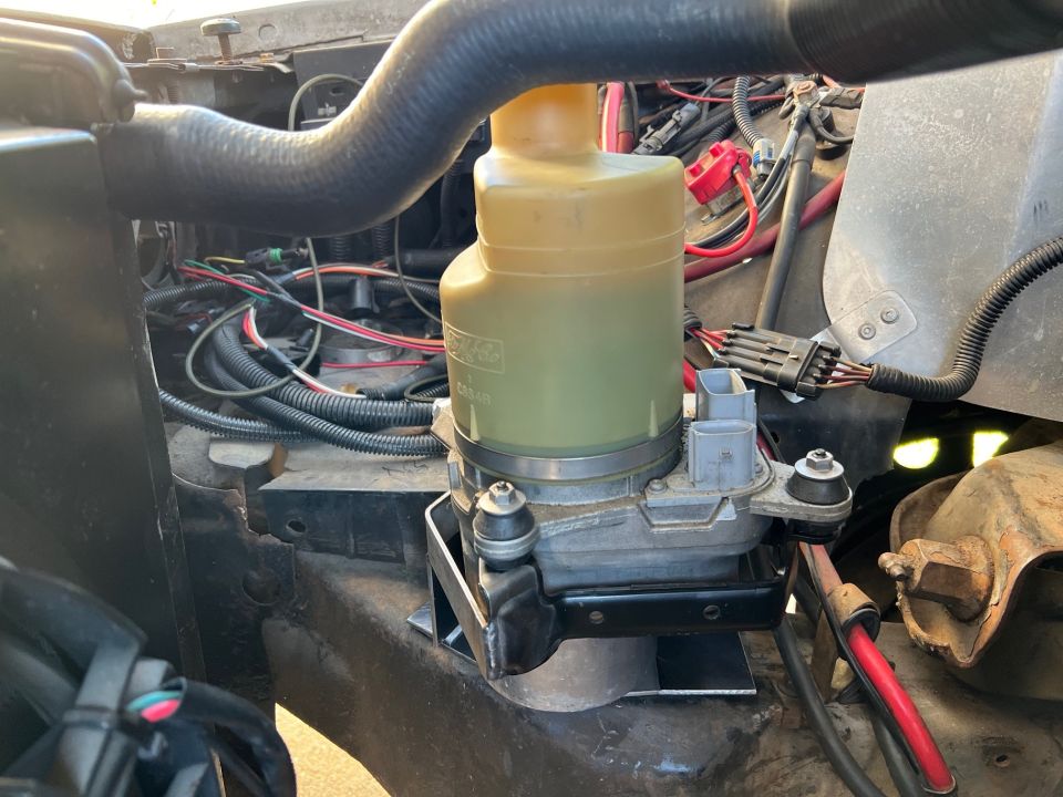 Volvo power steering pump sitting on the frame rail in the bracket tacked together.