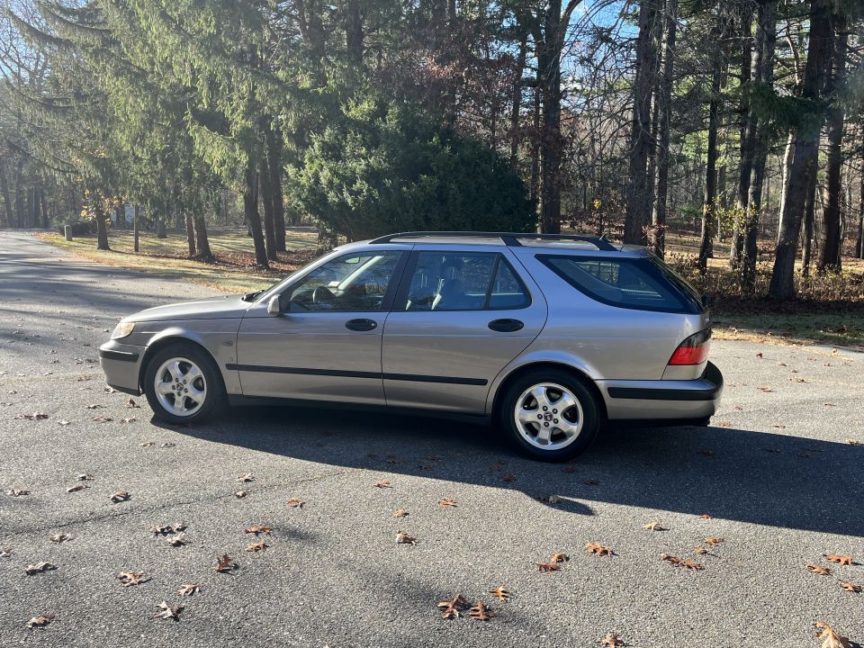 Silver 2001 SAAB 9-5 SE wagon parked on a tree-lined street