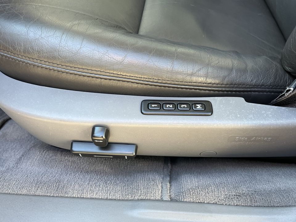 Car seat controls with buttons labeled 1, 2, 3, M and 'Side Airbag' text