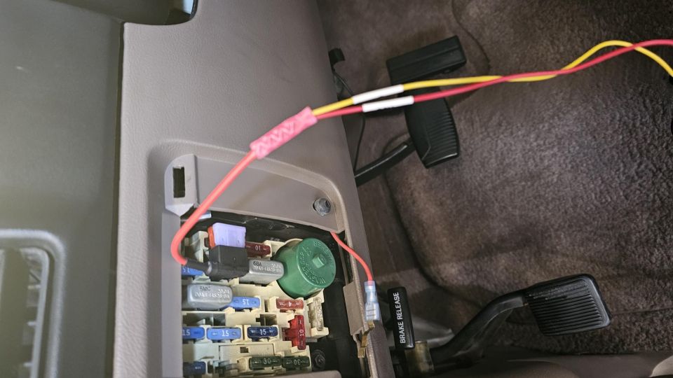 Fuse box with added wires and connectors. Brake release lever visible