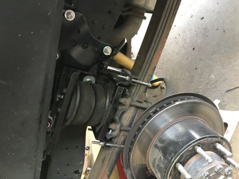 2008 Ford F-250 - Air suspension part installed on a truck's rear axle, adjacent to the brake rotor.