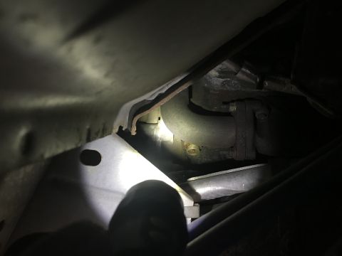 2008 Ford F-250 - Underside view of a vehicle's exhaust system components, including a pipe and bracket.