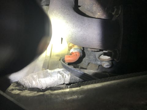 2008 Ford F-250 - Close-up view of an engine component with an orange hose connector and surrounding parts.