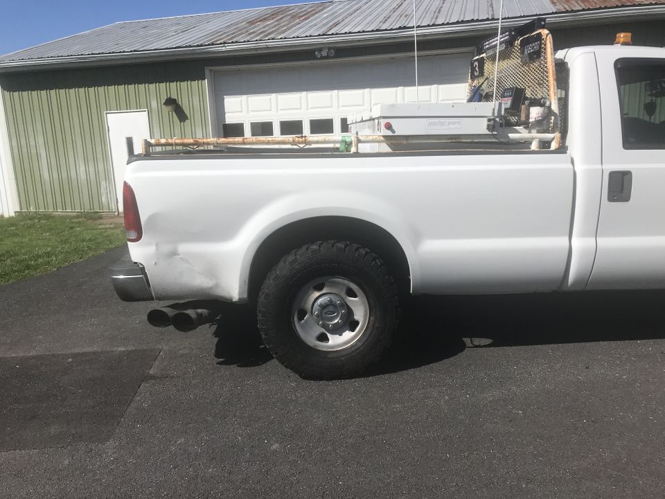 White 2008 Ford F-250 pickup truck, rear quarter view, with a utility bed and ladder rack