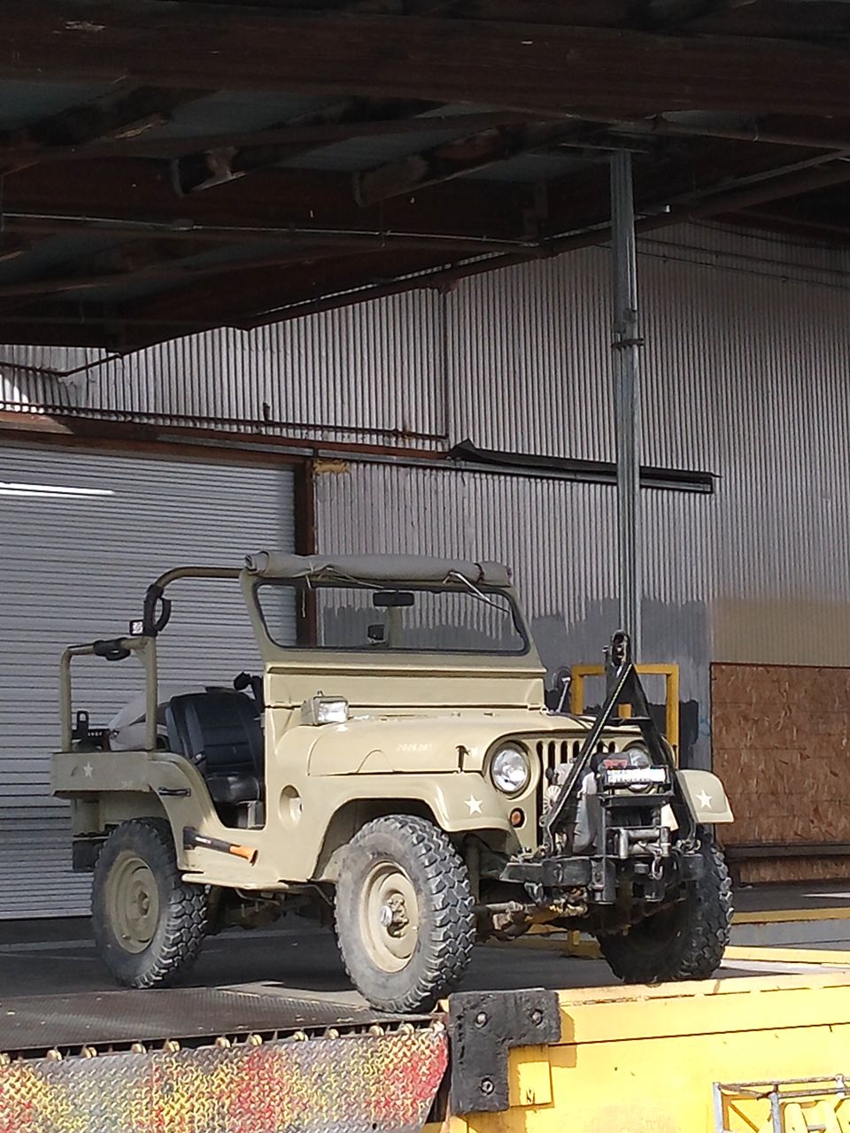 Tan 1952 Jeep CJ5 with winch and front-mounted equipment