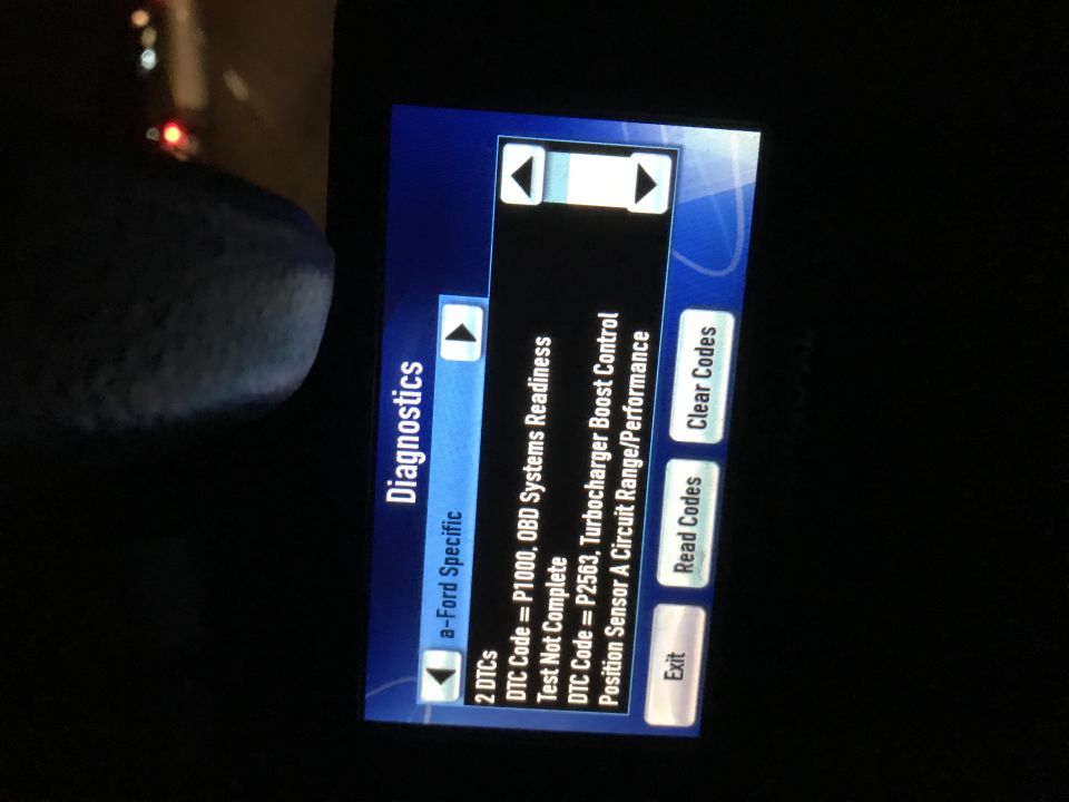 Diagnostic screen displaying DTC codes P1000 and P2563, with options to Read Codes, Clear Codes, and Exit