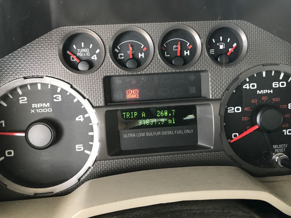 Dashboard gauges showing RPM, speed, turbo PSI, temperature, fuel level, and trip odometer with 91831.9 miles