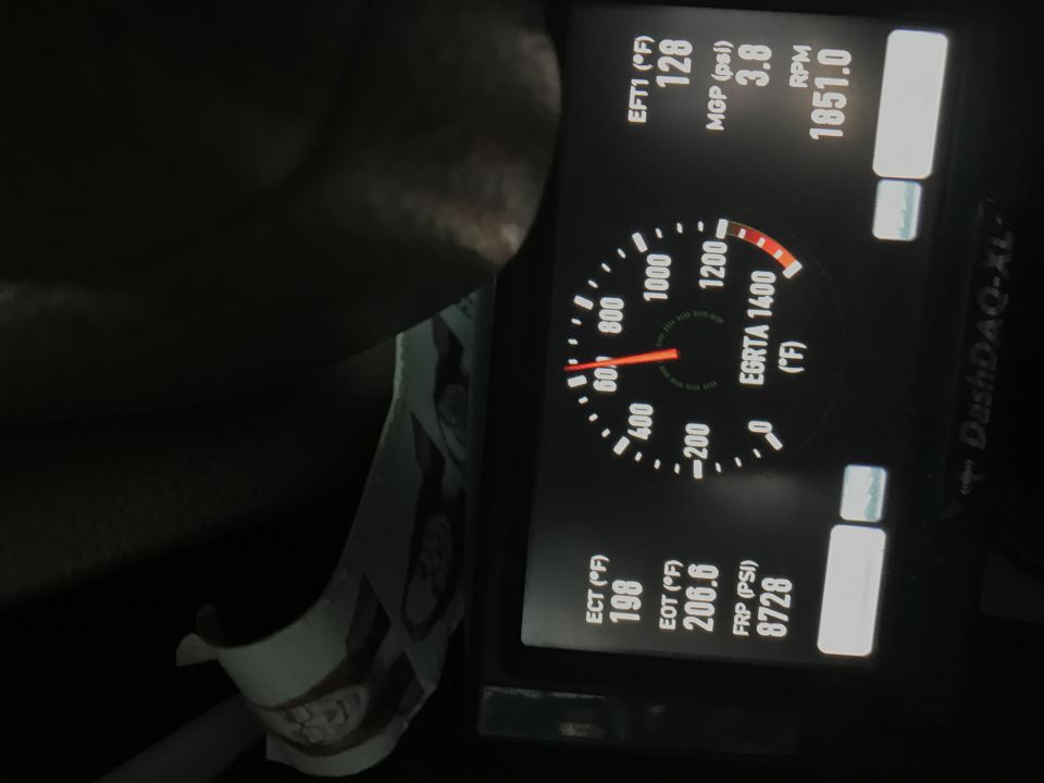 Digital dashboard display showing engine data and gauges.