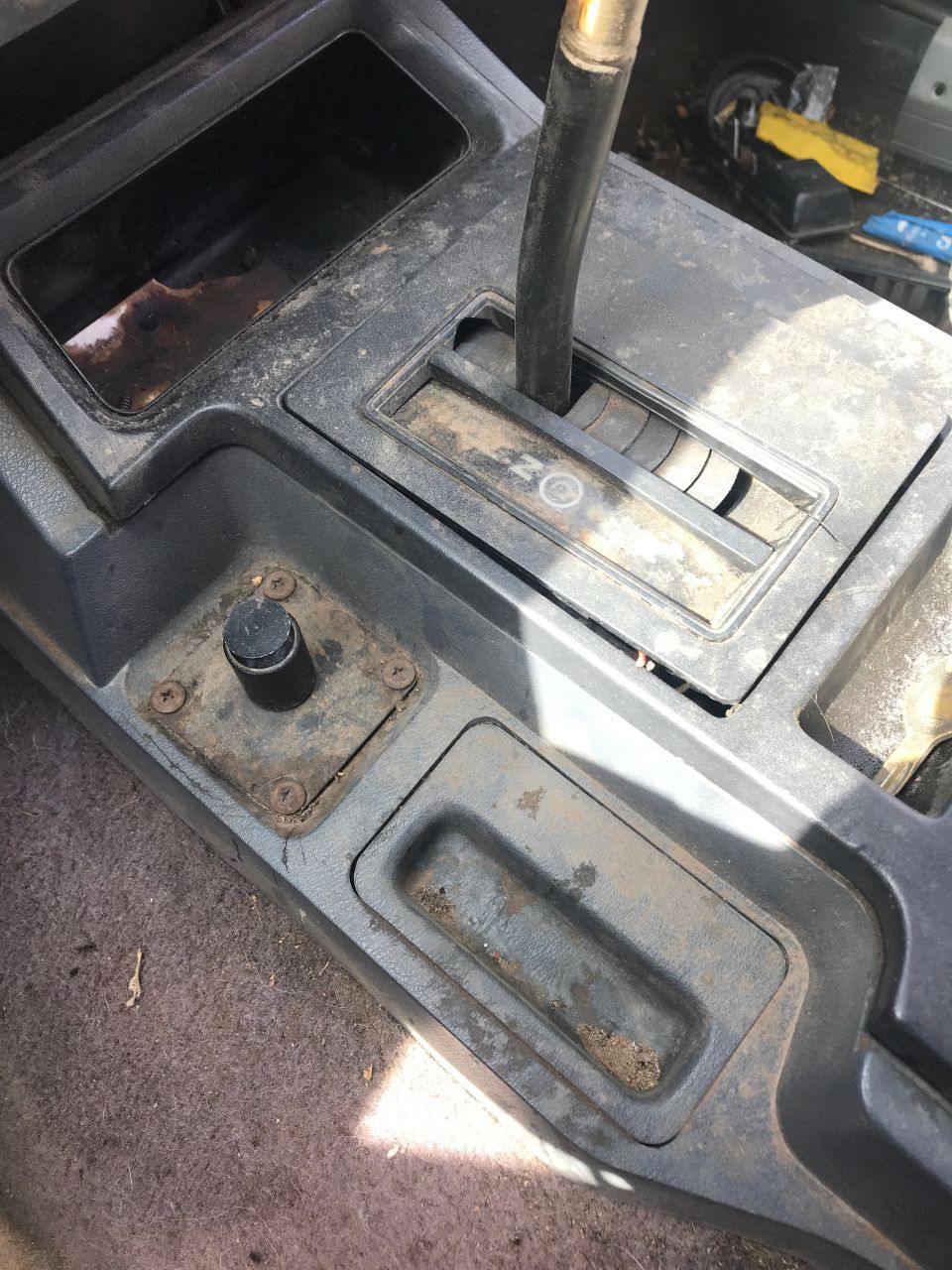 Interior of a 1996 Jeep Cherokee center console with gear shifter and storage.