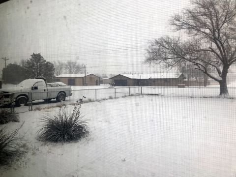 2008 Ford F-250 - A silver 2008 Ford F-250 sits parked on a snow-covered lot, with several outbuildings visible behind a chain-link fence.