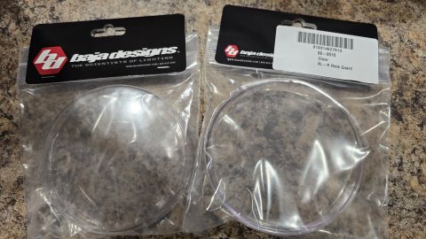 2024 Subaru Impreza - Two clear protective covers for Baja Designs XL-R lights are shown in their packaging.