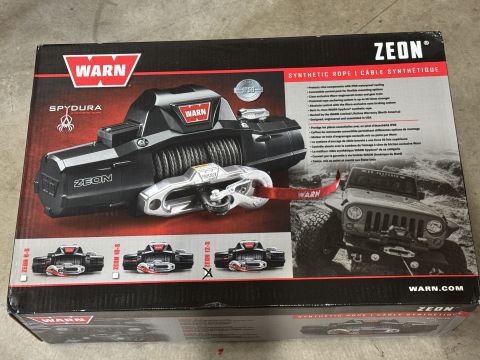 2022 Jeep Wrangler - Packaging for a Warn Zeon winch, product details and an image of a Jeep Wrangler.
