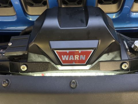 2022 Jeep Wrangler - Warn winch installed on the front bumper of a blue vehicle.