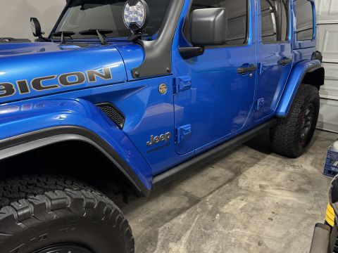 2022 Jeep Wrangler - Side view of a blue Jeep Wrangler Rubicon, showing the N-Fab step removal.