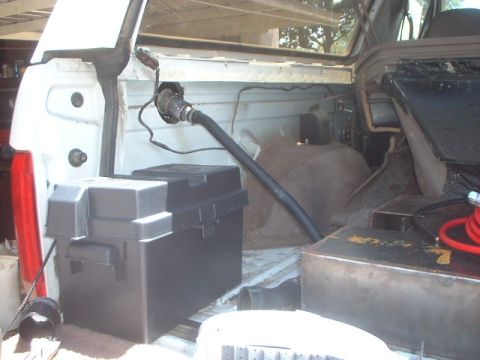 1995 Ford Bronco - view from the back. The fuel goes through the black hose into the tank and the air and fumes escape through the outer tube (missing).