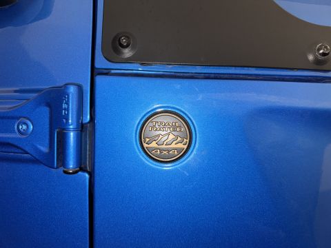 2022 Jeep Wrangler - Close-up of a blue vehicle door the Trail Rated 4x4 badge.