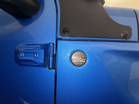 2022 Jeep Wrangler - Blue 2022 Jeep Wrangler door with Trail Rated 4x4 badge and Supermotors.net watermark.