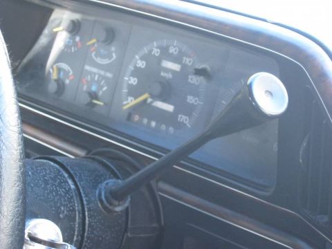 1988 Ford Bronco - Close-up of the dashboard showing the speedometer and automatic transmission shifter.