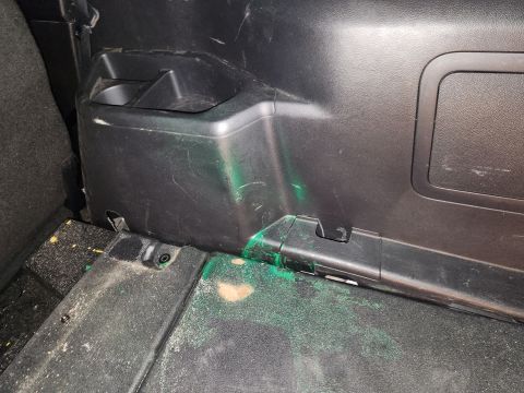2016 Ford Explorer - The interior has scuffs & stains. Apparently, a can of green spray paint leaked or exploded back here.