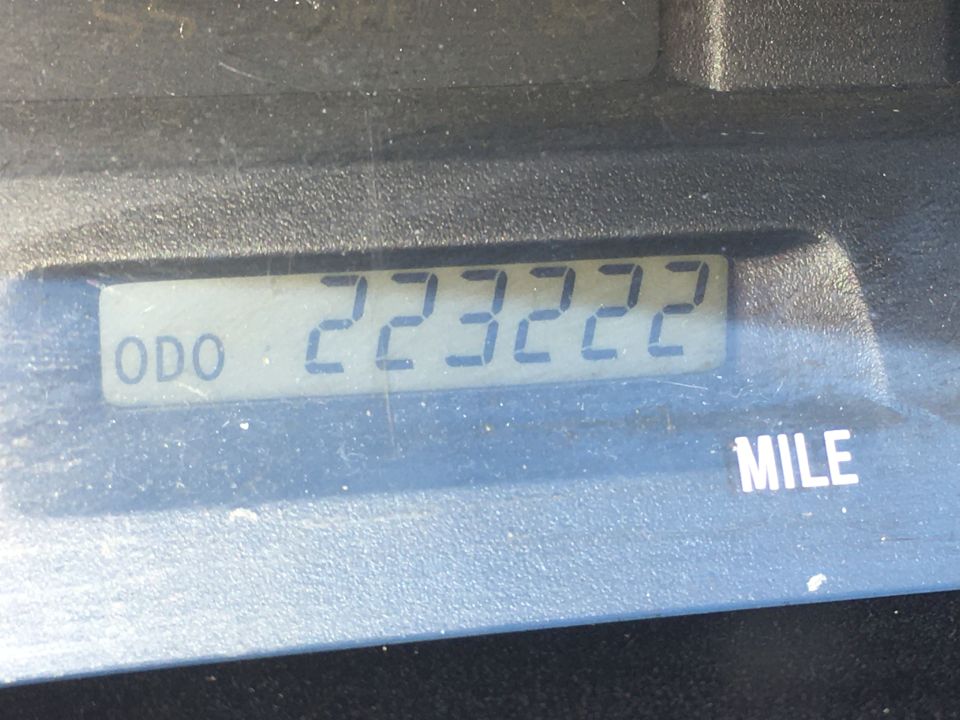 Digital odometer showing 223,222 miles with MILE label on instrument cluster