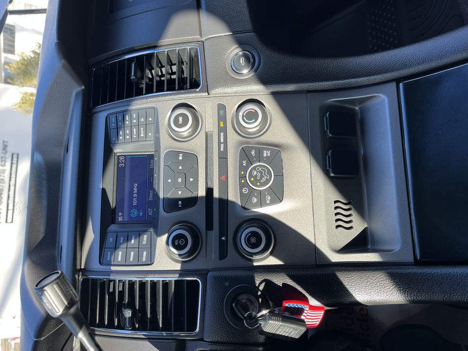 Center dashboard stack with Ford radio, climate controls and air vents