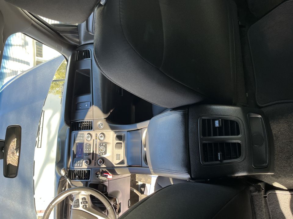 Interior view of dash, center stack and front seats with rear vents