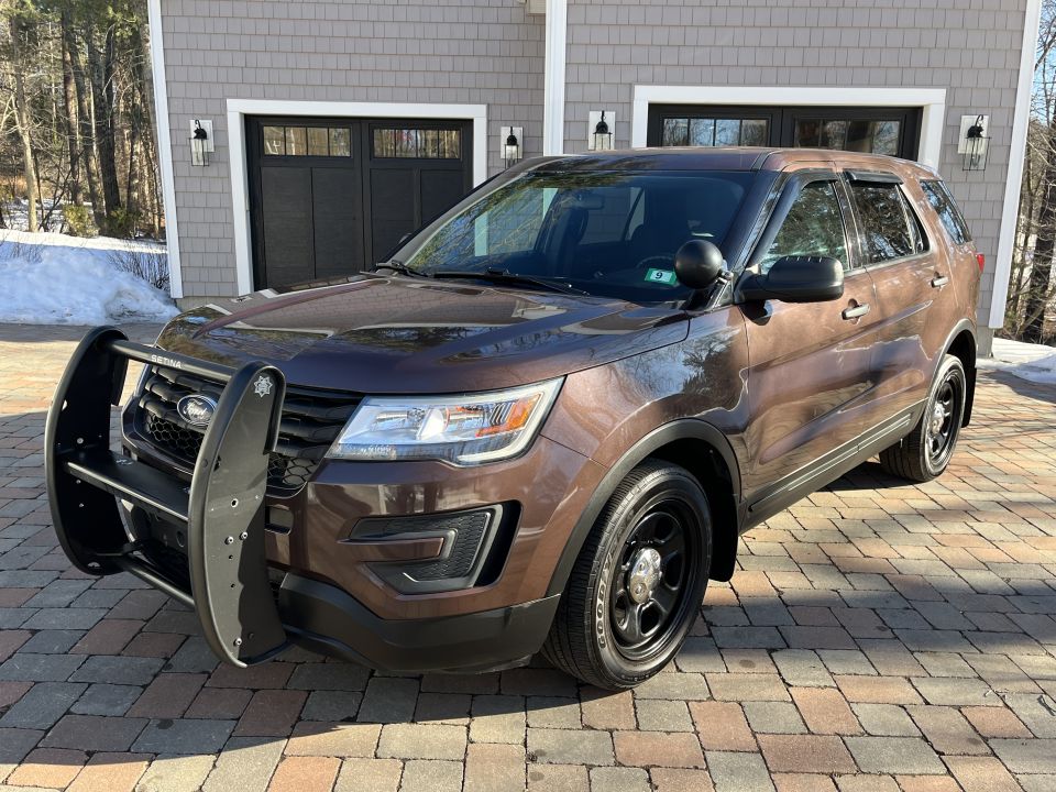 Front view of a brown Ford Explorer Police Interceptor with push bar