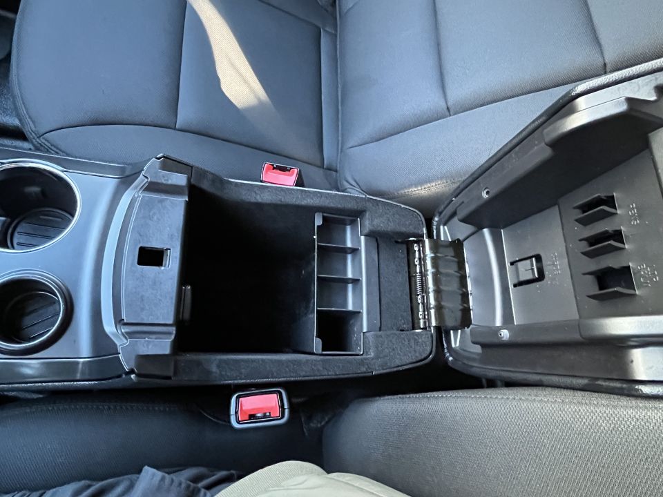 Ford Explorer center console storage bin and seat belt buckles, open lid