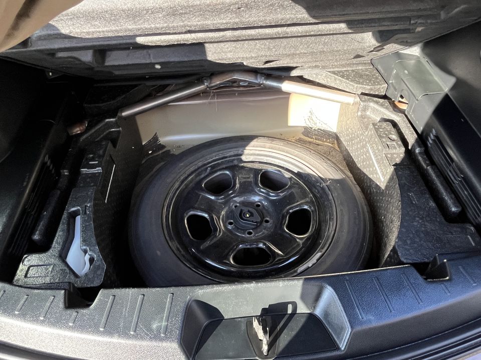 SUV spare tire stored in cargo compartment