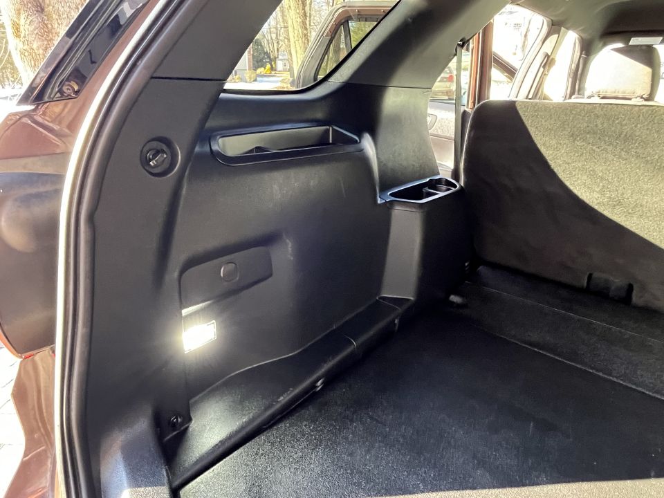 SUV cargo-area side trim panel with grab handle