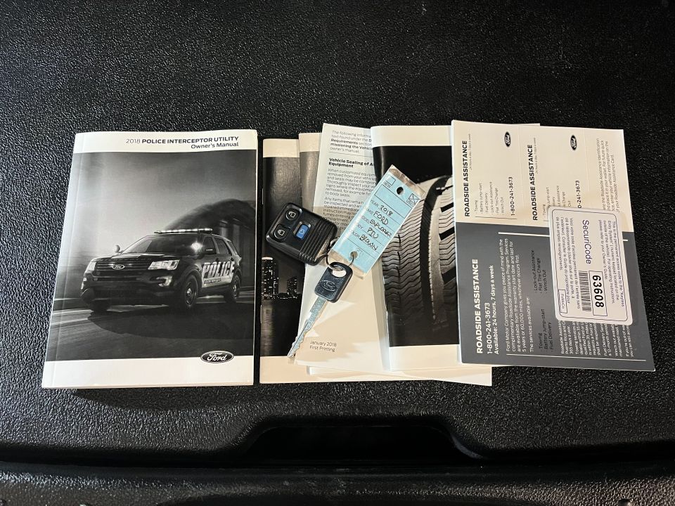 Ford Police Interceptor Utility owner's manual and roadside assistance literature with key