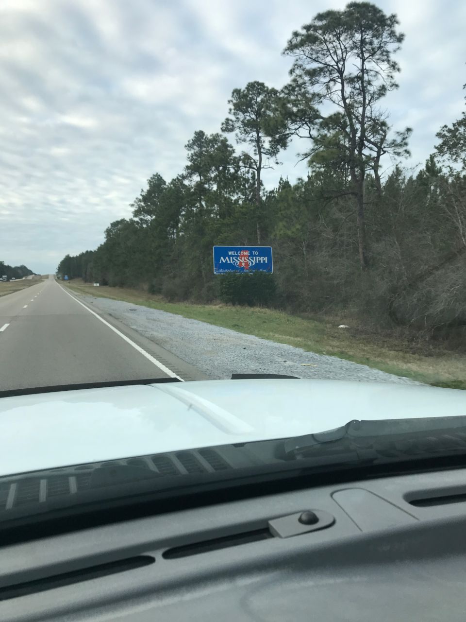 Welcome to Mississippi highway sign seen through vehicle windshield