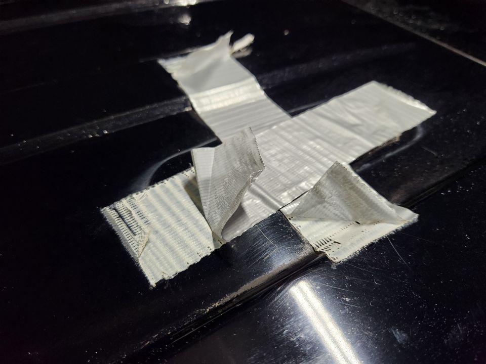 This cheap duct tape has been on here long enough for the backing to separate from the adhesive & fibers more easily than from the paint.