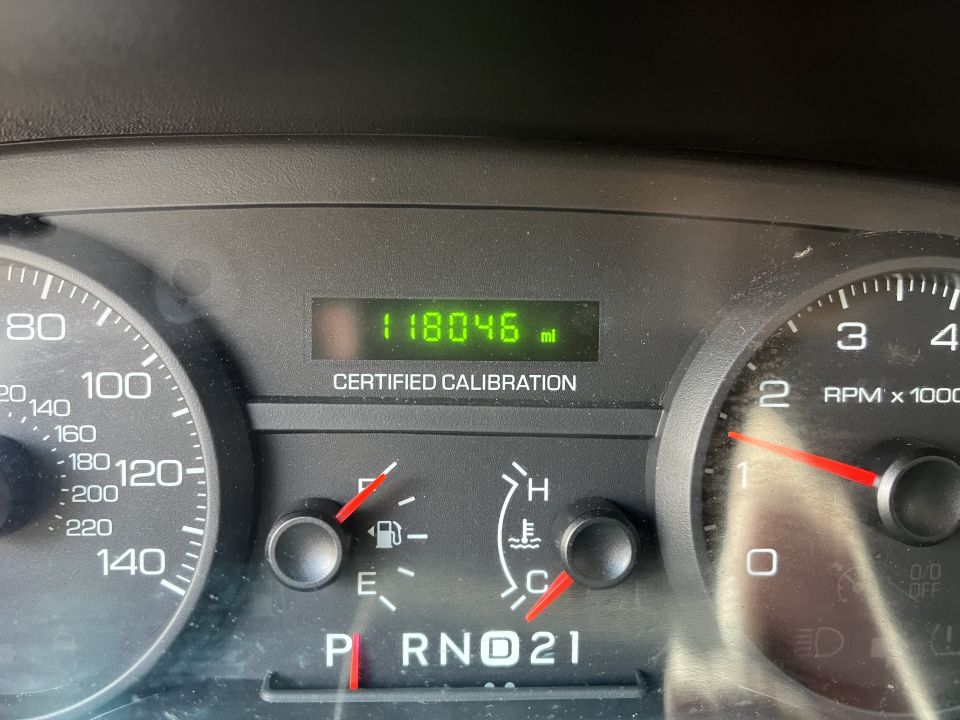 Instrument cluster gauges showing 118046 miles