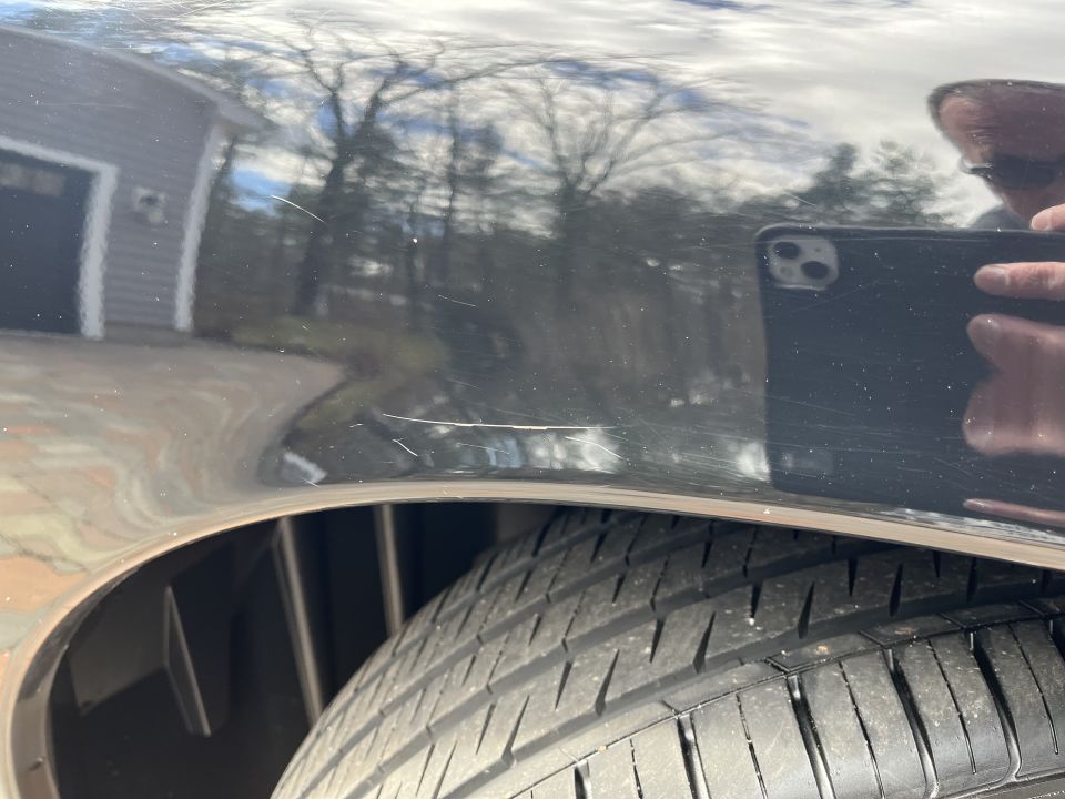 Close-up of a fender and tire with reflections