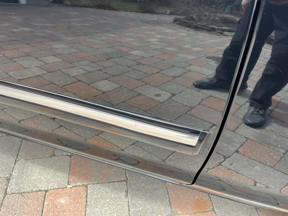 Chrome rocker trim along a vehicle body side