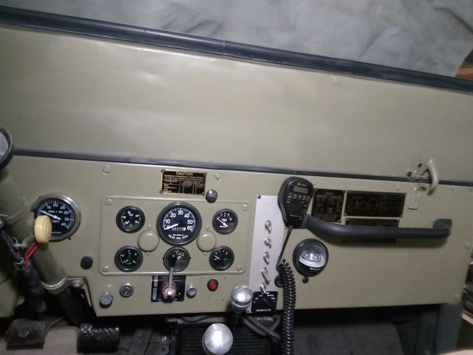 Vintage Jeep CJ5 dashboard with gauges and CB radio microphone