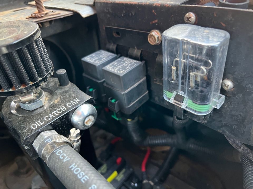 Engine bay with oil catch can and relays