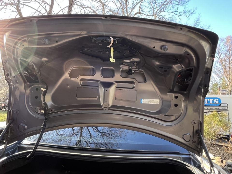 Underside of an open Ford Taurus trunk lid