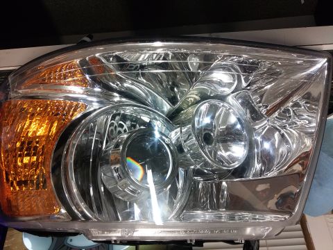 2004 Ford Expedition - I used a dremel to open the original hole of the headlight bulb large enough so i can fit the projector inside. drilled a small for for the…